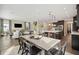 Open-concept living space with a large dining table adjacent to the kitchen island with views to the staircase at 2280 Minfarm Way # 529, Mount Pleasant, SC 29466