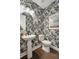 Stylish powder room with patterned wallpaper, pedestal sink, and modern fixtures at 2280 Minfarm Way # 529, Mount Pleasant, SC 29466