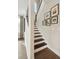 Modern staircase with black treads, white risers, and decorative wall art at 2280 Minfarm Way # 529, Mount Pleasant, SC 29466