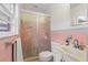 A bathroom featuring pink tiling with a shower enclosed in a frosted glass frame at 257 Druid Rd, Charleston, SC 29407