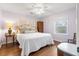 A comfortable bedroom featuring hardwood floors, an inviting window, and a ceiling fan at 257 Druid Rd, Charleston, SC 29407