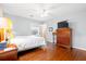 A cozy bedroom with hardwood floors, a ceiling fan, and an inviting window view at 257 Druid Rd, Charleston, SC 29407