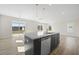 Open kitchen layout with a large island, stainless steel appliances, and hardwood flooring at 2838 Otranto Rd, North Charleston, SC 29406