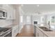 Open kitchen with white cabinets, granite countertops, and stainless steel appliances at 2838 Otranto Rd, North Charleston, SC 29406