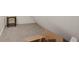 Cozy attic space with neutral carpet and white walls provides a quiet and functional area at 285 Grove St, Charleston, SC 29403