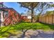 Spacious backyard featuring lush green grass, privacy fence, and a shade tree for outdoor enjoyment at 285 Grove St, Charleston, SC 29403