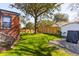 Expansive backyard with healthy green grass, bordered by a wood fence offering privacy at 285 Grove St, Charleston, SC 29403