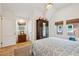 Airy bedroom featuring beautiful windows, a dark wardrobe, and hardwood floors at 285 Grove St, Charleston, SC 29403