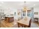 Open concept dining area with wood floors, chandelier, and view of kitchen at 285 Grove St, Charleston, SC 29403