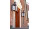 Detailed front entrance featuring a wooden door, elegant sidelights, and classic lantern sconces at 285 Grove St, Charleston, SC 29403