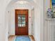 Inviting entryway with hardwood floors and view of front door with transom window at 285 Grove St, Charleston, SC 29403
