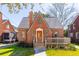 Captivating brick home with manicured lawn, detailed porch, and inviting architectural elements at 285 Grove St, Charleston, SC 29403