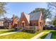 Inviting brick home with a tidy lawn, stylish porch, and timeless architectural design at 285 Grove St, Charleston, SC 29403