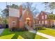 Stunning brick home with lush lawn, quaint porch, and elegant architectural details at 285 Grove St, Charleston, SC 29403