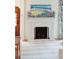 Elegant fireplace with marble surround, decorative mantle, and beach-themed artwork at 285 Grove St, Charleston, SC 29403