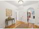 Bright foyer with hardwood floors, an ornate console table, and an archway into the living room at 285 Grove St, Charleston, SC 29403