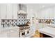 Well-appointed kitchen featuring tile backsplash, stainless steel range, and abundant counter space at 285 Grove St, Charleston, SC 29403