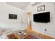 Living room showcases hardwood floors, a mounted TV, and bright natural light at 285 Grove St, Charleston, SC 29403