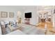 Bright living room with hardwood floors, white walls, light gray rug, archway, and view into dining room at 285 Grove St, Charleston, SC 29403