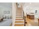 Bright, open staircase leading to the main living area and kitchen with bar stool seating at 285 Grove St, Charleston, SC 29403