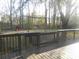 Large backyard featuring mature trees, a swing set, and plenty of space for outdoor activities at 315 King Charles Cir, Summerville, SC 29485