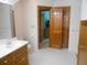 Bright bathroom with wood cabinets, a white sink, and a view into another room at 315 King Charles Cir, Summerville, SC 29485