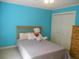 Cozy blue bedroom with a bed, a dresser, and a closet with white doors at 315 King Charles Cir, Summerville, SC 29485