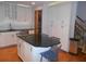 Bright kitchen with white cabinets, modern appliances, black countertops and an island with seating for four at 315 King Charles Cir, Summerville, SC 29485