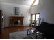 Spacious living room with a cozy fireplace, large windows, and comfortable seating at 315 King Charles Cir, Summerville, SC 29485