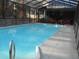 Enclosed in-ground pool with patio furniture and hot tub for relaxation at 315 King Charles Cir, Summerville, SC 29485