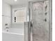 Bathroom with a bathtub, walk-in shower, and large window at 320 Abercom Place Dr, Moncks Corner, SC 29461