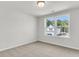 Bright bedroom with plush carpeting and a large window offering backyard views at 320 Abercom Place Dr, Moncks Corner, SC 29461