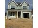 Charming two-story home with a craftsman style front elevation and an attached two-car garage at 320 Abercom Place Dr, Moncks Corner, SC 29461
