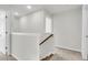 Upstairs hallway with wooden handrail and carpet leading to various rooms at 320 Abercom Place Dr, Moncks Corner, SC 29461