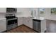 Modern kitchen featuring stainless appliances, white cabinets, and stone countertops at 320 Abercom Place Dr, Moncks Corner, SC 29461