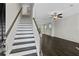 Inviting living room with hardwood floors, fan, and staircase leading to the upper level at 320 Abercom Place Dr, Moncks Corner, SC 29461