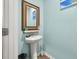 Charming powder room with pedestal sink, decorative mirror, and light blue walls at 324 Spruce Ivy St, Moncks Corner, SC 29461