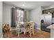 Cozy breakfast nook with modern farmhouse table, wood floors, and stainless steel refrigerator at 324 Spruce Ivy St, Moncks Corner, SC 29461