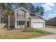Charming two-story home with a two car garage, manicured lawn, and solar panels on the roof at 324 Spruce Ivy St, Moncks Corner, SC 29461