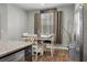 Bright kitchen nook features dark cabinets and stainless steel fridge, next to a window with neutral curtains at 324 Spruce Ivy St, Moncks Corner, SC 29461