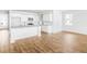 Open-concept kitchen flowing into a dining area with ample natural light and wood flooring at 336 Dickerson Ln, Lincolnville, SC 29485
