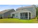 Backyard view highlights a screened porch for outdoor entertaining and relaxation at 336 Dickerson Ln, Summerville, SC 29485