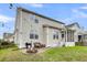 Inviting backyard with a fire pit, grill, patio, string lights, and a screened porch at 366 Clayton Dr, Charleston, SC 29414
