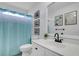 A bright white bathroom featuring a toilet, sink, and blue shower curtain at 366 Clayton Dr, Charleston, SC 29414