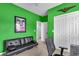 A green bedroom featuring a black futon, closet, and a door that leads to another room at 366 Clayton Dr, Charleston, SC 29414