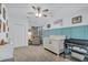 A Bedroom featuring a crib, changing table, glider, and blue paneling at 366 Clayton Dr, Charleston, SC 29414