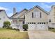 Charming home featuring a well-manicured lawn, inviting front porch, and convenient two-car garage at 366 Clayton Dr, Charleston, SC 29414