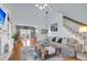Bright living room with a large sectional sofa, wooden floors, and staircase at 366 Clayton Dr, Charleston, SC 29414
