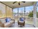 Relaxing screened porch with serene views, furnished with a wicker couch and chair at 366 Clayton Dr, Charleston, SC 29414