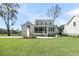 Beautiful backyard with a spacious lawn and an inviting outdoor fireplace, perfect for relaxation and entertaining at 3864 Summerton St, Mount Pleasant, SC 29466